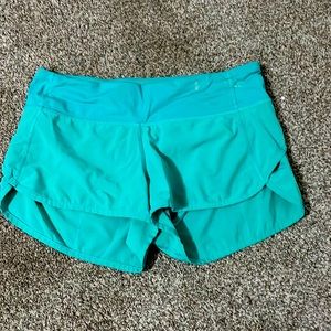 bright teal colored lululemon running shorts